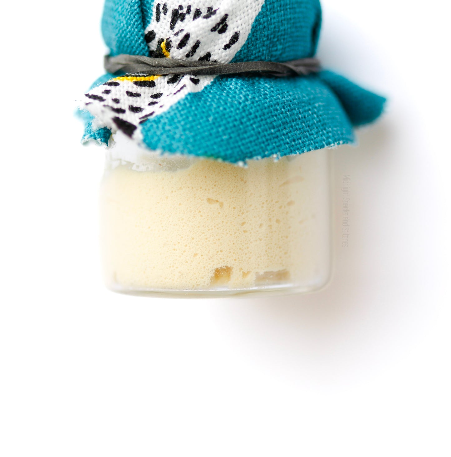 Detail of peak active sourdough starter bubbles formed inside jar